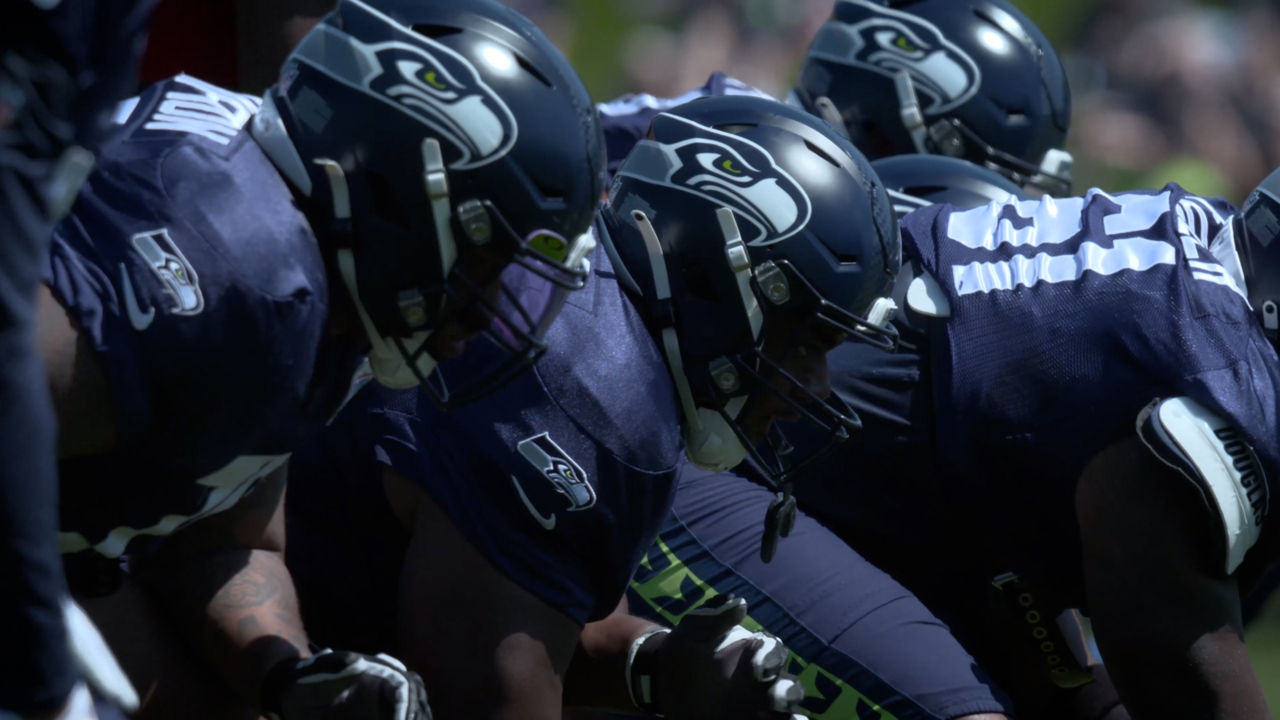 Seattle Seahawks football players linemen in full pads and uniform